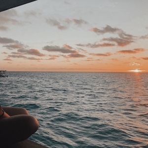 Sunset over the ocean seen from floating bar in Fiji